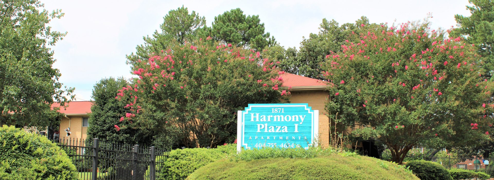 harmony plaza apartments leasing office sign